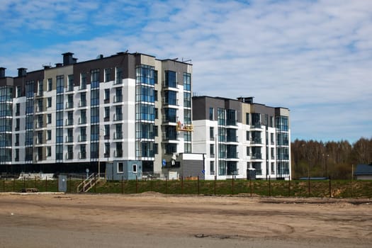 A very large and spacious apartment building designed with an abundance of windows, offering plenty of natural light and beautiful views
