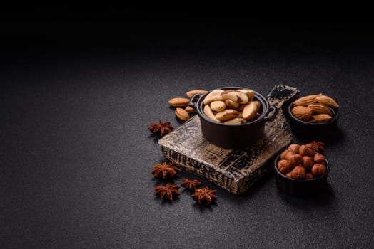Brazil nut kernels in ceramic bowl on dark concrete background