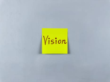 Sticky note with the word Vision written on it, pinned on white background. Photo symbolizes foresight, goals, and inspiration. Perfect for illustrating concepts of vision and future aspirations