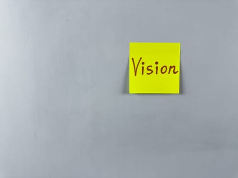 Sticky note with the word Vision written on it, placed on white background. Ideal for illustrating themes of foresight, goals, and inspiration. Great for concept creation