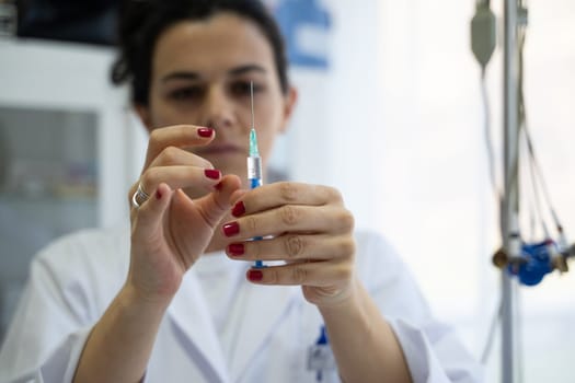 A focused nurse in a white lab coat carefully prepares a syringe for an injection in a professional healthcare environment