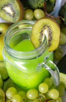 Antioxidant green fruit and vegetable shake .Vegetarian food ingredients.Healthy food concept. Variety of organic fruits and vegetables. Vegan menu. Vertical real picture