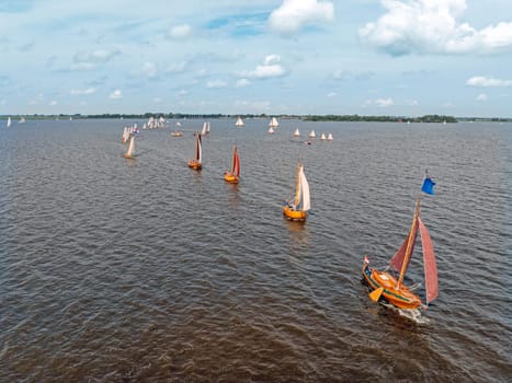 Aerial from admiral sailing with ancient wooden ships on the Heegermeer in Friesland the Netherlands