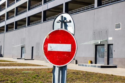 A striking red no entry sign juxtaposed with a modern building faade