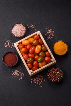 Tomatoes of different colors as a vegetable meal. Multicolored background consisting of cherry tomatoes