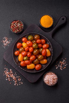 Tomatoes of different colors as a vegetable meal. Multicolored background consisting of cherry tomatoes