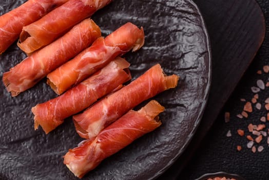 Cheese and meat, jamon or prosciutto rolled into a roll. Antipasti or delicacies for the festive table