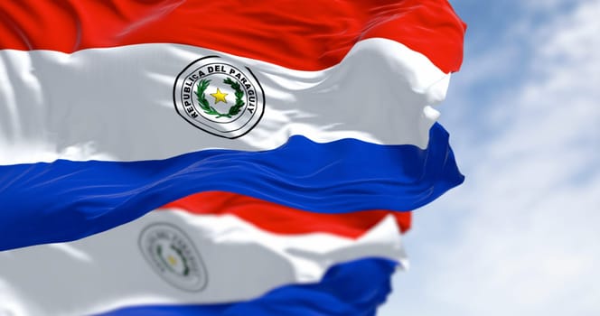 Two Paraguayan flags waving in the wind with red, white and blue tricolor inspired by the French flag. Identity, independence, and self-determination. 3d illustration render. Rippled fabric.