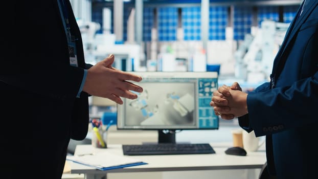 Photovoltaics factory manager and investor shaking hands, reaching agreement for producing sustainable green energy. Businessmen in solar panels facility finalize partnership with handshake