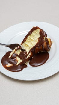 Delicious and Indulgent Cheesecake with Rich Chocolate Fudge Sauce Topping for Dessert Lovers.