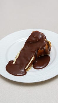 Close-up of a slice of New York-style cheesecake on a white plate