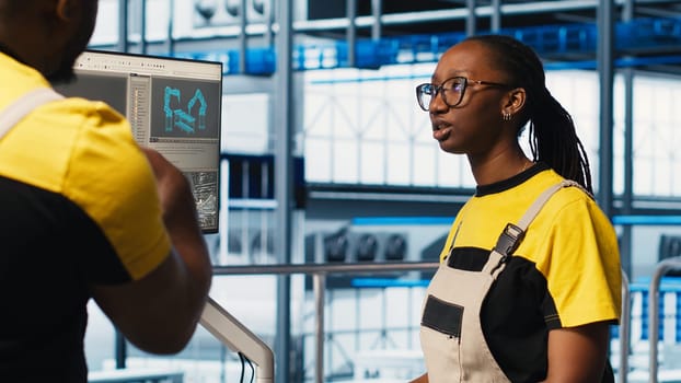Engineering team in photovoltaics smart factory cooperating to diagnose damaged IoT sensors. Industry 4.0 solar panels plant staff members working together to reduce downtime, camera A