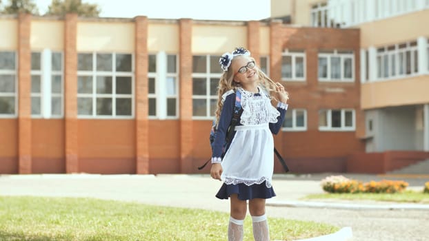 Russian 13 year old schoolgirl in a good mood with a backpack