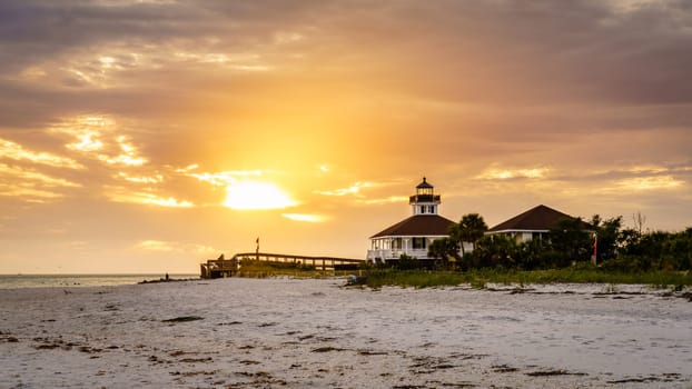 Scenic sunset over lighthouse and the beach in Воса Grande, Florida