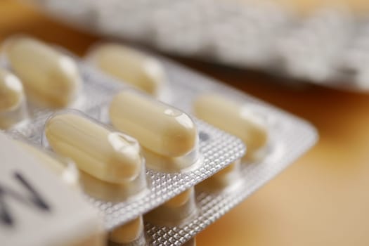 Close-up view of capsules in a blister pack, representing medication and health.