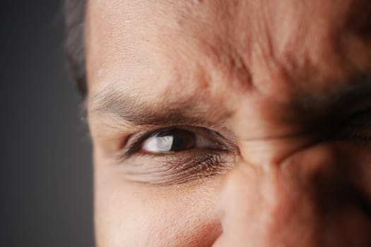 A man displays a strong emotional expression, focusing on his eyes and forehead.
