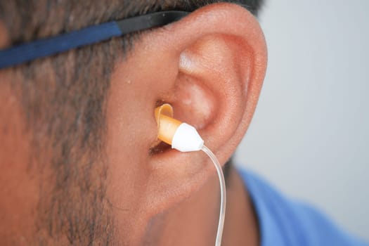 Ear protection being fitted by a person during a quiet event,