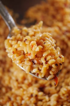 A spoonful of flavorful spiced rice ready to be enjoyed at the table.