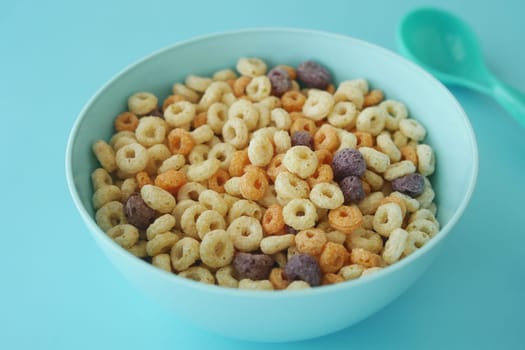A bowl filled with assorted colorful cereal pieces ready to eat.