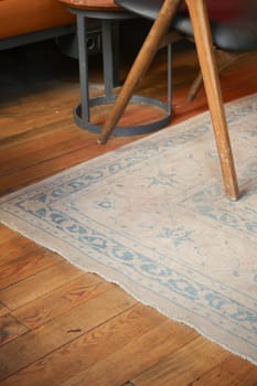a dirty rug and chair in a room,