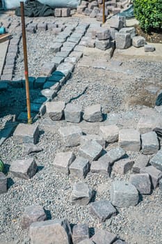 Making path - paving stones, installing and laying pavement stones on terrace, road or sidewalk.