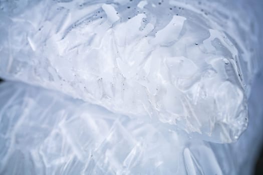 Closeup of tube ice inside a clear plastic bag. Convenient and lightweight packaging designed for easy transportation and storage. Hygiene and freshness for commercial and industrial applications.