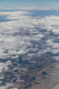 landscape in the sky with clouds from the window of an airplane
