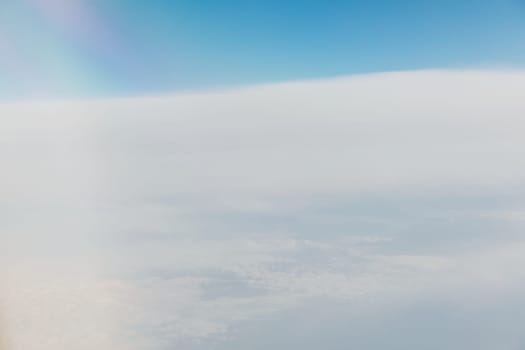 landscape in the sky with clouds from the window of an airplane