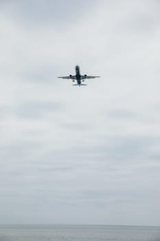 passenger plane flying in the clouds in the sky