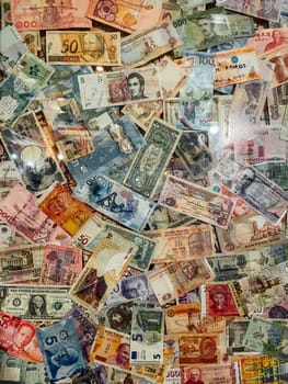 A lot of money from different countries currency as background