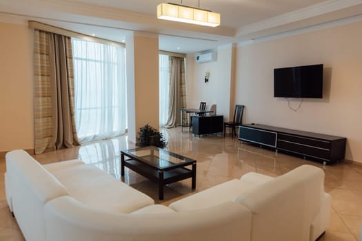 Interior of a living room with a sofa and a table with TV