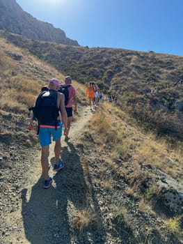 travelers climbing to the top of the mountain