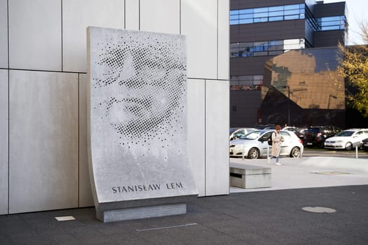 Wroclaw, Poland - October 24, 2024: Sculpture of Stanislaw Lem located next to the Library building of Wroclaw University of Science and Technology. The three-metre-high work, made of Strzegom granite and designed by Grzegorz Niemyjski, PhD, professor at the Academy of Fine Arts in Wroclaw, depicts the writer's face in the form of small holes drilled into the surface of a block of rock.