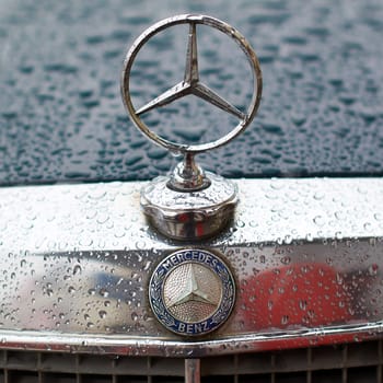 Lviv, Ukraine - Dec 09, 2017: Mercedes-Benz logo on a vintage classic Mercedes-Benz W114 released circa 1970 in Germany