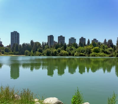 View over Lost Lagoon at old residential high-rises in downtown of Vancouver.