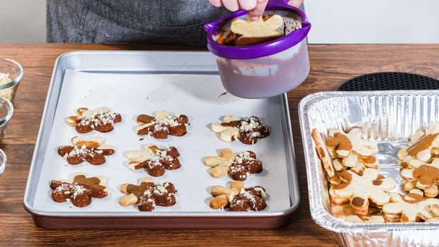 Crafting star-shaped holiday cookies dipped in chocolate and sprinkled with variety of toppings.