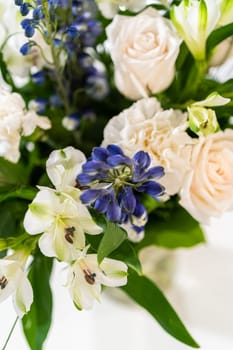 A stunning bouquet featuring fresh white roses and assorted flowers gracefully arranged in a vase, exuding timeless beauty.