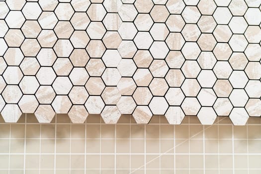 In the process of mounting peel and stick mosaic tiles onto a foam board, perfect for enhancing a food photography studio's aesthetic.