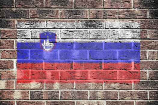 A Slovenia flag on old brick wall background