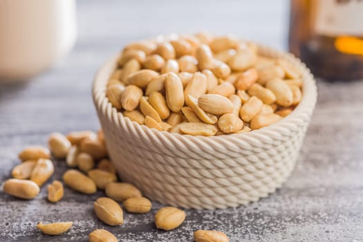 Roasted salted peanuts in bowl on a kitchen table
