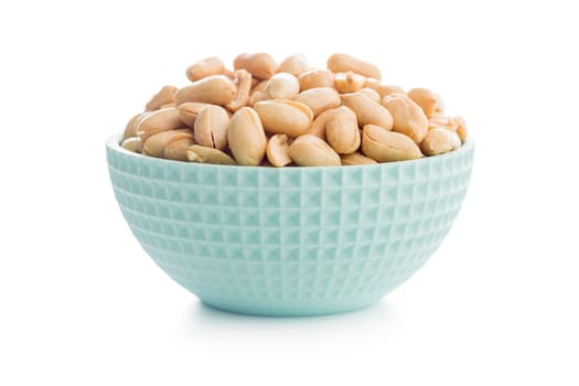 Roasted salted peanuts in bowl isolated on a white background.