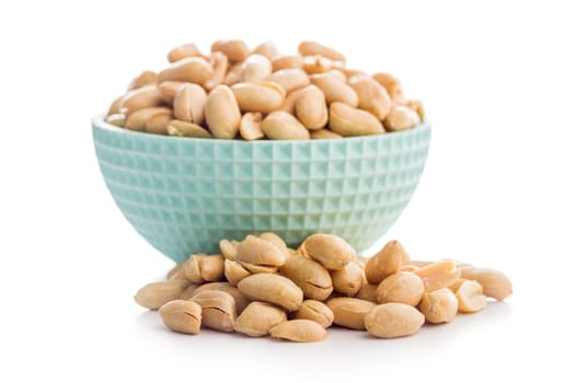 Roasted salted peanuts in bowl isolated on a white background.