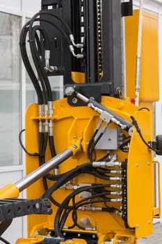 Part of bulldozer - mechanism of the bucket scraper, close up
