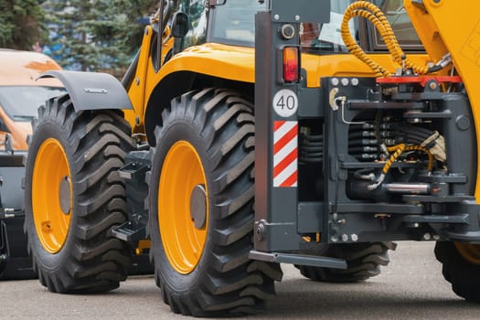 Yellow road constructor tractor - industrial equipment, horizontal