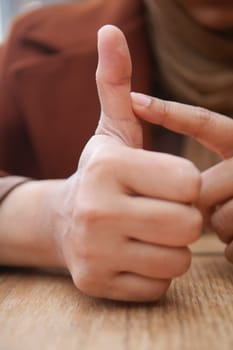 young woman suffering pain on her finger .