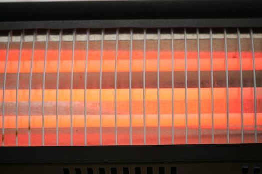 Radiant electric heater provides warmth during cold winter nights indoors.