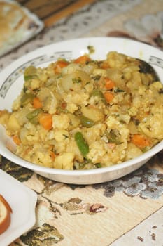 A colorful mix of vegetables and grains is served in a bowl ready to eat.