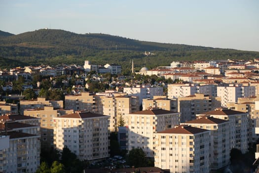 Expansive view of an urban area with modern buildings and hills.
