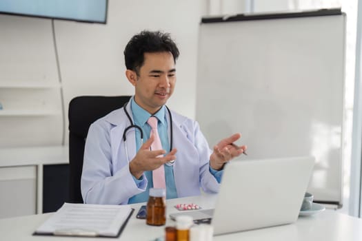 The physician actively discusses treatment options and patient engagement while showcasing medications during a telehealth session, exemplifying modern healthcare practices.