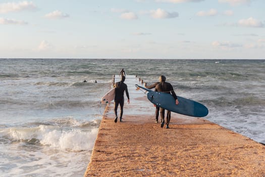 surfers on boards riding the waves in a storm